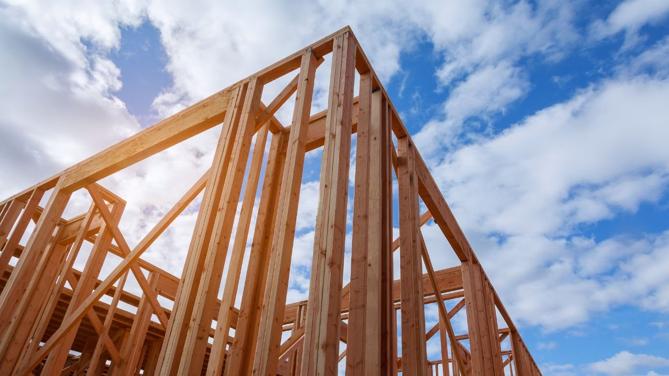 View of wooden framing for a building under construction, representing the quality work of remodeling contractors in the construction process.