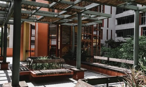 Modern outdoor pergola with wooden benches and metal framework, designed by Duluth Construction, highlighting custom carpentry and carpentry services for stylish urban spaces.