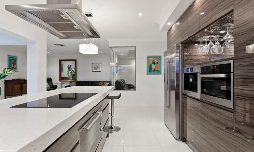 Modern kitchen with sleek countertops, built-in stainless steel appliances, and custom cabinetry by Duluth Construction. Elegant and functional open-concept design.