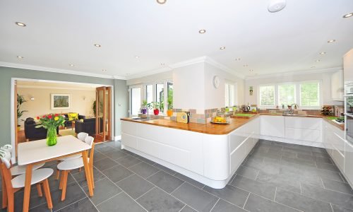 Spacious open-concept kitchen featuring modern cabinetry, custom countertops, and stylish backsplashes by Duluth Construction. A bright and functional design.