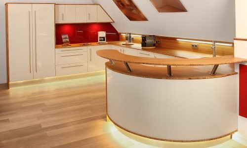 Modern kitchen with custom cabinetry, wood countertops, and under-cabinet lighting designed by Duluth Construction. Expert kitchen remodel for a sleek and functional space.