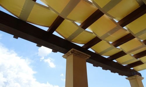 Elegant outdoor pergola with a woven fabric canopy, expertly crafted by Duluth Construction, showcasing custom carpentry and carpentry services for stylish and functional outdoor spaces.