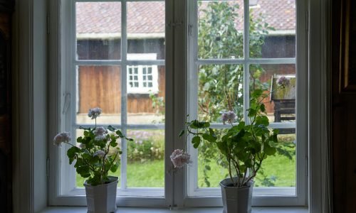 Cozy interior featuring a large window with a garden view, showcasing expert home window repair and window replacement Portland by Duluth Construction for enhanced durability and aesthetics.