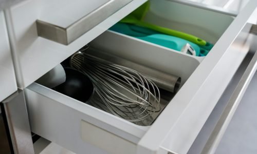 Modern kitchen storage with custom cabinetry and sleek metal handles by Duluth Construction. Designed for efficient organization and easy access.