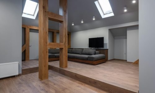 Modern attic living space with skylight window installation, featuring energy-efficient design by Duluth Construction.