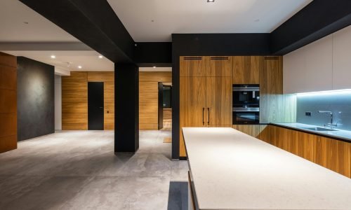 Modern open-concept kitchen featuring custom cabinetry, sleek countertops, and integrated lighting by Duluth Construction. A stylish and functional design.