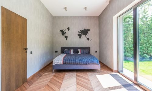 Modern bedroom with large energy-efficient windows installed by Duluth Construction, providing natural light and insulation for enhanced comfort.