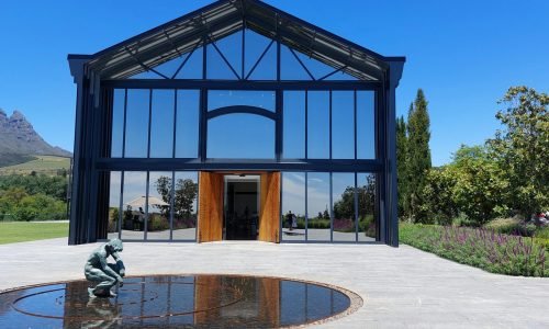 Stunning modern glass building with large custom windows and sleek entry doors, enhancing natural light and architectural design. Duluth Construction specializes in high-quality window and door installations for residential and commercial properties.