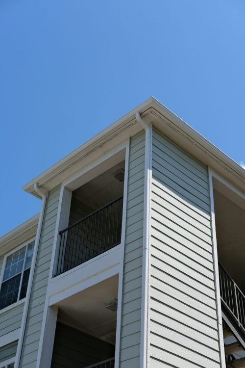 Apartment building with durable fiber cement siding and white trim. Duluth Construction specializes in high-quality fiber cement siding installation and repair for residential and commercial properties.